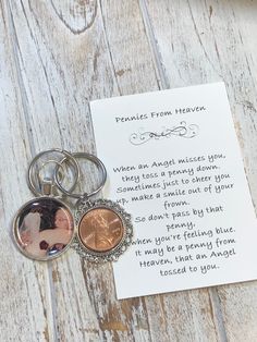 a keychain that has two pictures on it and a note attached to it