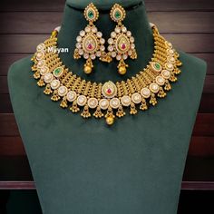 High end gold jewlery set in antique gold finish with kundan details. Inspire your style with real gold look necklace with ruby and green stone details from our royal wedding collection. Traditional gujrati and rajwadi jewelry to complete your look for wedding or any occasions.  All orders Ship same day if placed before 4:00 PM EST  Earring length: 2.5 inch Earring width: 1.2 inch Necklace length: Adjustable with dori closure. Create beautiful memory for any occasion with elegant jewelry for you Ceremonial Gold Plated Chandbali Kundan Necklace, Ceremonial Chandbali Kundan Necklace In Gold Plated, Gold Plated Kundan Necklace With Pallu For Diwali, Gold Plated Jewelry With Zari Work, Gold-plated Jewelry With Zari Work, Temple Jewelry Kundan Necklace For Marriage, Heavy Kundan Necklace In 22k Gold For Wedding, Heavy 22k Gold Kundan Necklace For Wedding, Gold Temple Jewelry Style Kundan Necklace For Marriage