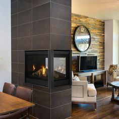 a living room filled with furniture and a fire place in the middle of a room