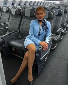 a woman sitting on an airplane seat with her legs crossed