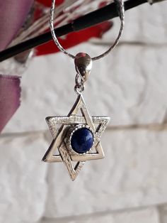 Jewish symbol of protection and balance. Sterling Silver Magen David necklace. Unisex necklace. Great gift for birthday, bar mitzvah, or holiday gift. Feature sterling silver Magen David handmade texture, Lapis Lazuli set in the center of the star. A silver chain connects to the Silver Star. Magen David size: 1.2\0.7 inch Gemstone size: 6mm. Length to order: 16-30 inches. Choose silver chain: wheat or foxtail. 🔸 All my creations made by me from Fine Materials, Gemstones, high quality. 🔸 Unique Silver Star Of David Birthstone Jewelry, Silver Star Of David Jewelry With Birthstone, Silver Star Of David Necklace With Gemstone, Silver Star Of David Necklace For Hanukkah, Silver Sterling Silver Necklace For Hanukkah, Hanukkah Sterling Silver Silver Necklace, Magen David Necklace, Handmade Texture, Jewish Symbol