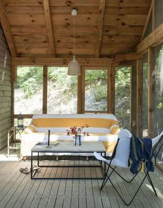 a couch sitting on top of a wooden porch