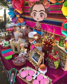 a table topped with lots of food and candy