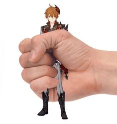 a hand holding a small figurine in it's palm