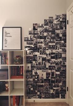 a book shelf in front of a wall with pictures on it and bookshelves