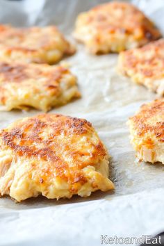 some crab cakes are sitting on a baking sheet and ready to be baked in the oven