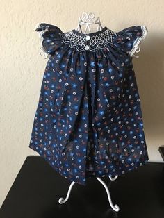 Size 6-9 Months Hand Smocked Baby Girls' Dress Navy Cute Cotton Smocked Dress For Daywear, Cute Cotton Smocked Day Dress, Bohemian Cotton Dress With Smocked Cuffs, Bohemian Cotton Smocked Dress With Smocked Cuffs, Peasant Style Cotton Dress With Smocked Back, Cotton Dresses With Smocked Cuffs For Playtime, Cute Blue Dresses With Smocked Cuffs, Cute Blue Dress With Smocked Cuffs, Summer Cotton Smocked Dress With Lace Trim