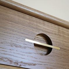 a close up of a drawer with a wooden handle