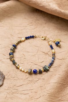 Discover the vibrant and stunning colors of the Blue Moon Collection in this eclectic bracelet! Gold Filled (Lead & Nickel Free) Pyrite, Lapis Lazuli, Sodalite, Abalone, Labradorite, Freshwater Pearl, Mother Of Pearl 7.5-8.5" adjustable length, with gold filled lobster claw clasp We hand select our natural materials, thus there may be slight variations in color and/or size that will not detract from the overall aesthetic. Our unique handcrafted designer jewelry for women is made in America, each Floyd Va, The Blue Moon, Silver Gold Earrings, Silver Gold Necklace, Pyrite Necklace, Flower Collage, Moon Collection, Beaded Jewelry Patterns, Gold Collection