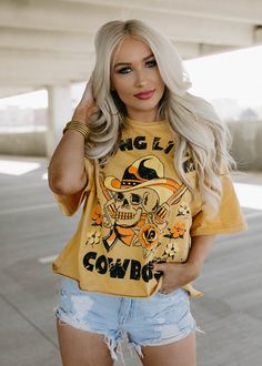 Long Live Cowboys Skull OVERSIZED 80's throwback distressed Cropped T- shirt available in faded mustard This Crop Jersey Tee slides right into streetwear style for Summer and Winter.. With oversized sleeves and a relaxed body, this on-trend tee drops a little lower in the back for an effortlessly cool feel. Fabricated from ultra-soft, lightweight Airlume cotton that's fit to flatter, this looser crop features a finished hem and neck binding.Features: Finished hem. Oversized sleeves. Neck binding Skull Print Tops For Spring Streetwear, Oversized Hip Hop Tops For Halloween, Casual Yellow Top For Halloween, Acid Wash T-shirt For Fall Streetwear, Fall Distressed Tops For Streetwear, Distressed Tops For Streetwear In Fall, Fall Hip Hop Short Sleeve T-shirt, Hip Hop Short Sleeve T-shirt For Fall, Trendy Oversized Skull Print Tops