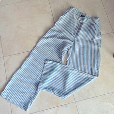 Juicy Couture 100% Silk Stripped Pants In Excellent Condition, Unworn -Waist Is Approximately 26” But Has Adjustable Belted Straps To Make Waist Size Larger Or Smaller - Length Is Approximately 38” From Waist To Hem - Inseam Is Approximately 27” - Seat Or Hip Is Approximately 18” - Straight Leg Pant With Leg Opening Approximately 10” - Pinstriped Colors Blue, White, Black, Yellow - Gold Hardware On Belt Loop & Logo On Front Button Chic Striped Linen Bottoms, Blue Striped Pants For Spring, Chic White Wide Leg Pants With Vertical Stripes, Blue Vertical Stripes Pants For Spring, High Waist White Pants With Vertical Stripes, Summer High Waist Wide Leg Pants With Vertical Stripes, Striped Wide-leg Linen Pants, Summer High Waist Vertical Striped Wide Leg Pants, Striped Linen Wide-leg Pants