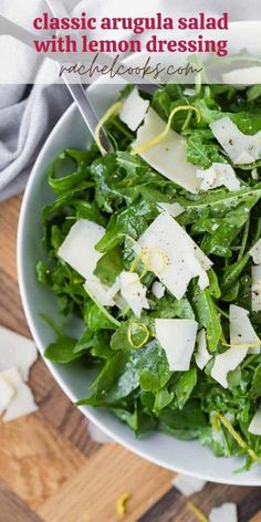 a white bowl filled with lettuce and cheese on top of a wooden table