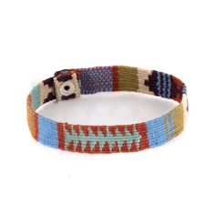 a multicolored bracelet with a metal buckle on it's end and a button in the middle