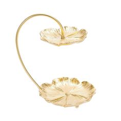 two gold plated metal flower shaped dishes on a white background with clippings