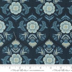 a blue and white flower pattern on a black background with a ruler in the foreground