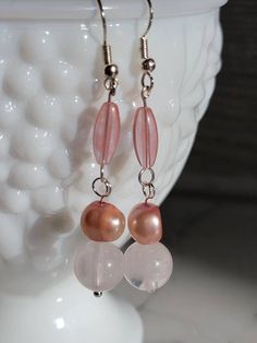 Earrings for the pink lover,cherry quartz drops to rose quartz to show the pale pink color and fresh water pearls with a luster to match. These earrings are hand made to be loved and enjoyed, they will be perfect for a fancy occasion, day at the park, or a day at work. Handmade Pink Crystal Earrings In Sterling Silver, Handmade Pink Crystal Sterling Silver Earrings, Feminine Pink Jewelry With Pearl Drop, Pink Teardrop Earrings With Natural Stones, Pink Sterling Silver Drop Pearl Earrings, Pink Pearl Jewelry With Natural Stones, Feminine Pink Pearl Drop Jewelry, Pink Rose Quartz Earrings With Natural Stones, Handmade Pink Crystal Dangle Earrings