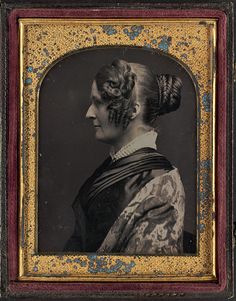 an old photo of a woman with braids in her hair