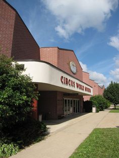 a brick building with a clock on it's side and the words circus world inside