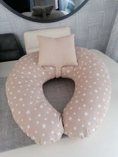 a round pillow with white stars on it