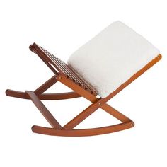 a wooden rocking chair with a white blanket on it's back and seat cushion