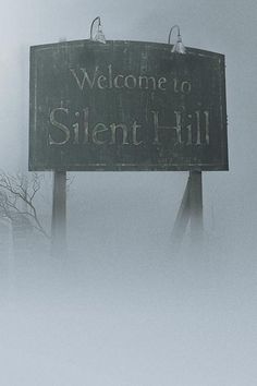 a sign that reads welcome to silent hill on a foggy day with trees in the background