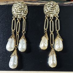 E1719 Dramatic Gold & Pearl Teardrop Statement Earrings Aprox 4" Drop Post Back Goldtone Stoppers Bundle & Save! Join The Live Shows! Automatically Save 25% On 3+! Buy With Confidence! 1000+ Listings Available! New Items Added Weekly! Party Cohost, Posh Ambassador & Mentor With 3000+ Sales! #Jesisfashionz #Statement #Jewelry #Fun #Fashion #Fashionjewelry #Style #Gunmetal #Statementearrings #Chunky #Funky #Diva #Largeearrings #Runway #Boutique #Ear #Accessories #Accessory #Different #Glam #Model Elegant White Metal Chandelier Earrings, White Metal Clip-on Pearl Earrings, White Clip-on Metal Pearl Earrings, Clip-on White Pearl Earrings, Metal Pearl Drop Teardrop Earrings For Party, White Metal Pearl Drop Clip-on Earrings, Pearl Drop Teardrop Earrings For Party, White Metal Clip-on Earrings With Pearl Drop, White Metal Dangle Bridal Earrings