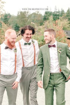 three men in suits and bow ties are smiling at each other as they walk together