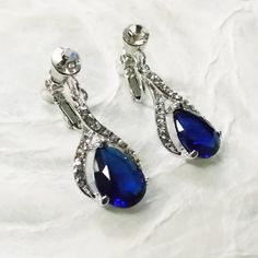 Navy Sapphire Blue Halo Drop Clip-On Earrings Swarovski Crystal and Cubic… Formal Crystal Teardrop Clip-on Earrings, Blue Wedding Earrings With Diamond Accents, Formal Sapphire Crystal Earrings, Sapphire Dangle Crystal Earrings For Formal Occasions, Sapphire Crystal Dangle Earrings For Formal Events, Sapphire Crystal Dangle Earrings For Formal Occasions, Blue Clip-on Earrings For Wedding, Elegant Blue Clip-on Earrings For Weddings, Elegant Jeweled Blue Crystal Earrings