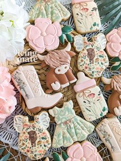 decorated cookies are sitting on a wicker basket