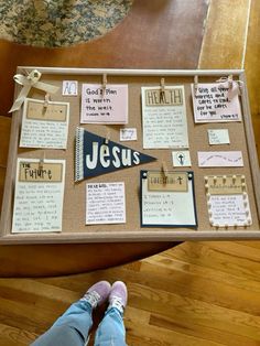 a person standing in front of a bulletin board with words and pictures attached to it