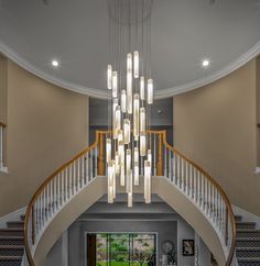 a large foyer with chandelier and stairs leading up to the second floor area