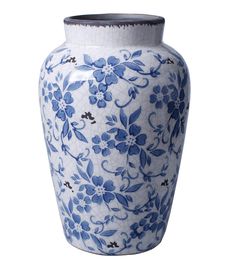 a large blue and white vase with flowers on it's sides, sitting in front of a white background