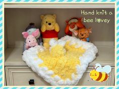 winnie the pooh baby blanket and other stuffed animals on a dresser with text that reads, hand knit a bee lovelyy