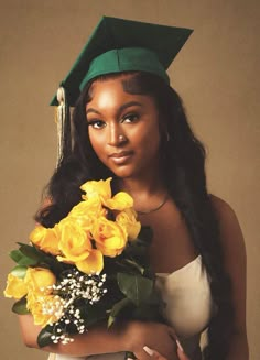 a woman wearing a graduation cap holding flowers