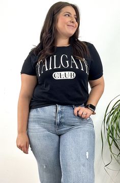 Tailgate Club Graphic Tee Show off your game day spirit with the Tailgate Club Graphic Tee. Perfect for sporting events or casual hangouts, this tee features a fun and bold graphic that celebrates the best of tailgating traditions. Size: S-L Color: Black Leopard Loafers, Baby Pearls, Footie Pajama, Dressy Dresses, Curvy Dress, Plaid Tops, Fitted Sweater, Long Sleeve Cardigan, Game Day