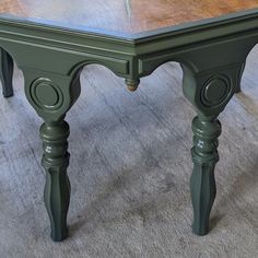 a green table sitting on top of a carpeted floor