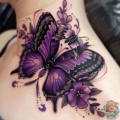 a woman's back with purple butterflies and flowers on her stomach, in the shape of a butterfly