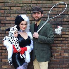 a man and woman dressed up in costumes posing for a photo with a baby doll