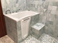 a white bath tub sitting next to a walk in shower