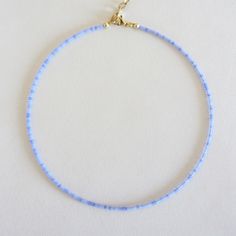 Cornflower blue seed beads choker necklace, Long dainty beaded necklaces, Tiny choker, 14k gold jewelry for her There are two clasp options, one is a stainless steel clasp and chain, the second option the clasp and chain are made of brass with 14k gold plating so the necklace will not lose its look over time! Measure the length of your neck with a measuring tape or you can use any thread, rope, or cable for telephone and after apply the measurements to a regular ruler. Choker is 12 inches with a 2 inches adjustable extender chain. 14 inches full length. The necklace is made using size 10/0 Czech beads (approximately 2.3mm.) Dainty Choker Beads For Gift, Blue Beaded Necklaces With Delicate Chain And Round Beads, Dainty Adjustable Choker With Tiny Beads, Blue Jewelry With Tiny Beads For Gift, Blue Beaded Necklaces With Delicate Chain, Minimalist Blue Beads For Gift, Minimalist Blue Jewelry With Tiny Beads, Dainty Adjustable Choker With Spacer Beads, Dainty Blue Beaded Necklaces With Delicate Chain