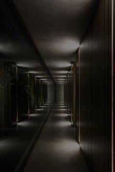 an empty hallway is lit up at night