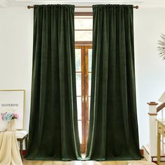 a green curtain hanging in front of a window