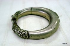 vintage antique tribal old silver hollow two part Bracelet or bangle (Kadla or kadiya) from Rajasthan India. worn by tribal people of Rajasthan. Nice worn piece with great antique look. See similar sample in "Traditional jewelry of India" by Oppi Untracht.Note - Please check pictures carefully for more detail.Inner diameter side to side - 5.3 cm(2")Inner circumference - 16.3 cm (6.4")Outer diameter side to side - 7.7 cm(3")width max. - 1.7 cm(0.7")weight - 76.5 gramsMaterial - Silver and origina Antique Metal Bangle For Ceremonial Occasions, Antique Oxidized Bangle For Wedding, Heavy Vintage Bangle For Ceremonial Occasions, Vintage Heavy Bangle For Ceremonial Use, Traditional Bangle Bracelet With Antique Finish, Antique Hand Cast Bangle Bracelet, Antique Oxidized Silver Bangle, Hand Cast Bohemian Bangle, Traditional Antique Finish Cuff Bangle Bracelet