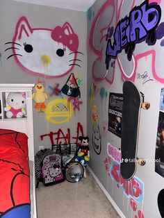 a bedroom with hello kitty graffiti on the walls and bed in the corner, along with a skateboard