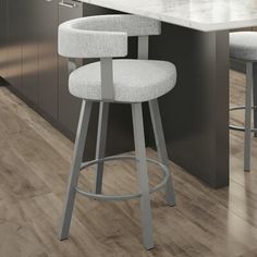 an image of a kitchen setting with bar stools and counter top spacer area