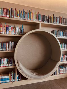 a chair that is sitting in front of a bookshelf with many books on it