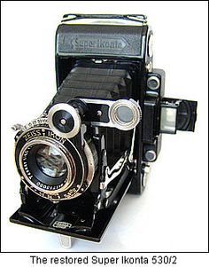 an old fashioned camera sitting on top of a table