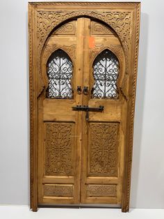 an ornate wooden door with two glass panels