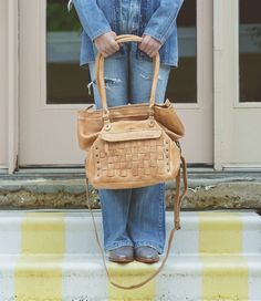 Grace your shoulder with this beautifully woven handbag, we call her MIRIAM.  We love this bag, as her interior is so spacious, but the best thing?  The base of MIRIAM is wide, so she sits upright.  Flat bottoms rule.  Padded shoulder straps are another thing we are loving, but an adjustable and removable crossbody strap comes with it as well to switch up your look. Finally, a zip-top closure gives you security piece of mind. MIRIAM checks a lot of boxes, give her a closer look, ~wink~. Woven Leather Satchel For On-the-go, On-the-go Satchel Shoulder Bag With Braided Handles, Intrecciato Weave Satchel Tote For On-the-go, Leather Satchel With Intrecciato Weave For Daily Use, Leather Shoulder Bag With Intrecciato Weave For Travel, Casual Leather Shoulder Bag With Intrecciato Weave, Casual Leather Intrecciato Shoulder Bag, On-the-go Woven Leather Shoulder Bucket Bag, Everyday Woven Leather Satchel Bucket Bag