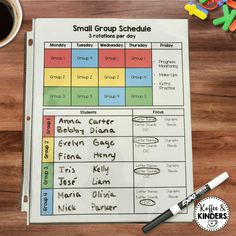 a small group schedule with markers and crayons on the table next to it